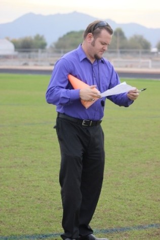 New coach Shane Meyer checking his formations while his team gets ready for their first game of the season.  