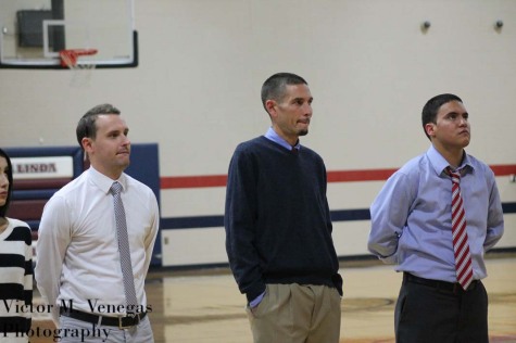“Assistant Coach Chase Boydston (left), Head coach Joshua Haagensen (Center), and assistant coach Andy J. Enciso (left) standing at attention for the playing of the national anthem” 